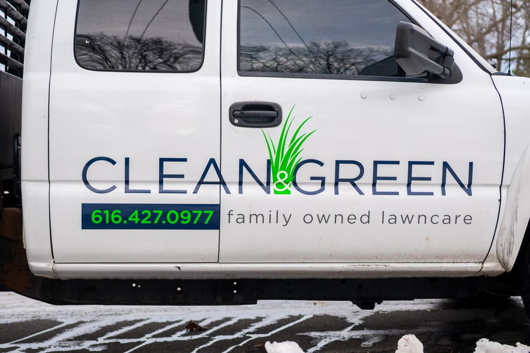 Clean & Green lawncare truck with contact number 616.427.0977; family-owned business.